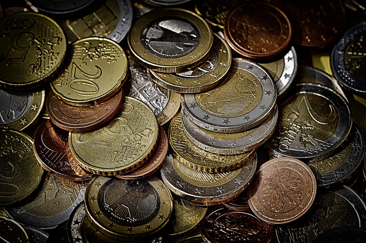 A focused hand precisely arranging foundational financial building blocks, such as stacked coins and clearly categorized budget charts, to construct a visible, ascending path that symbolizes financial understanding, control, and future growth.