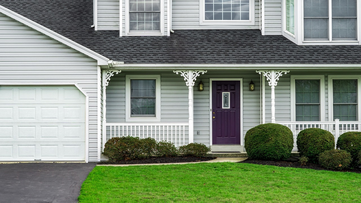A stylized, secure key with a house-shaped head, resting on a neatly organized stack of financial documents and digital charts, symbolizing the guided and structured process of securing a home loan.