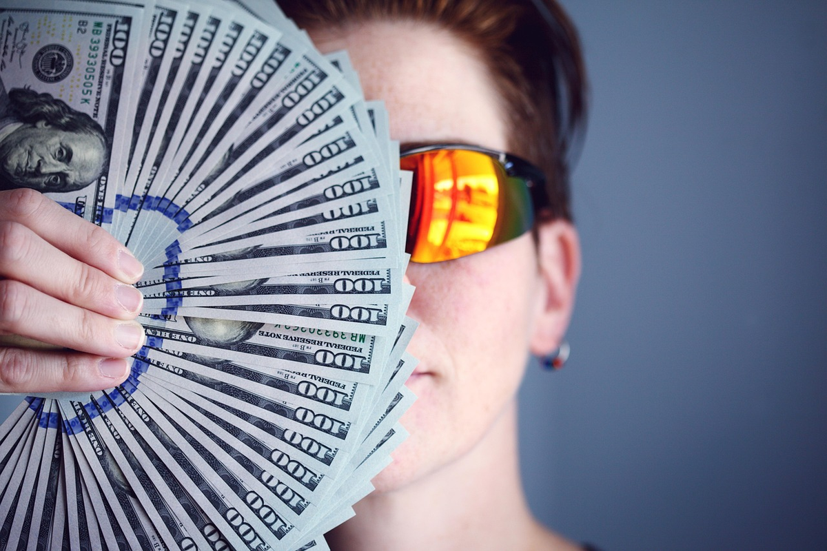 A hand strategically balancing a diverse portfolio of financial assets on a rising growth chart, with a bullseye target visible in the distance, representing investment planning and goal achievement.