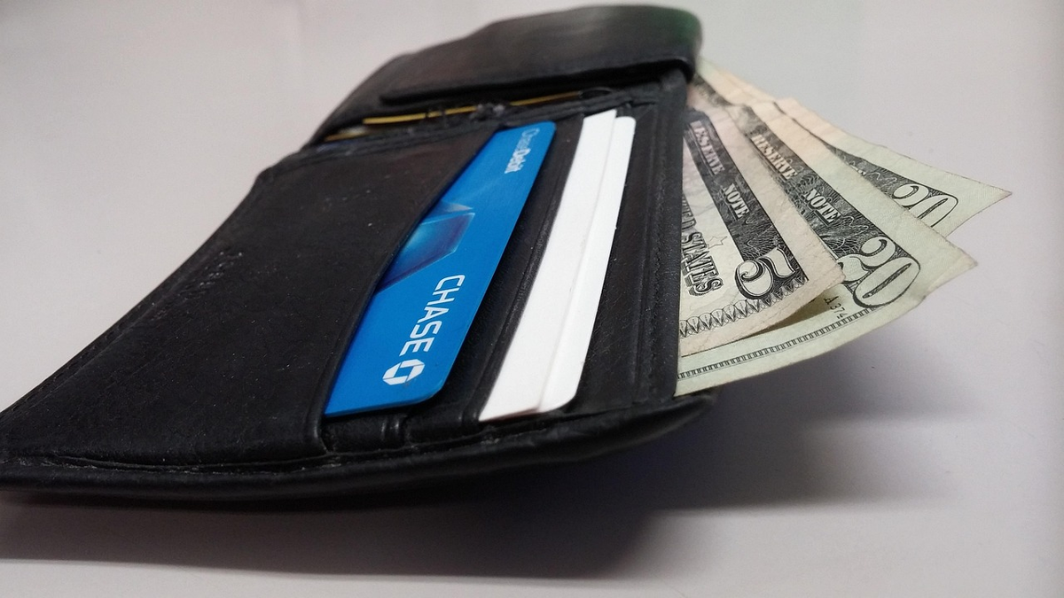 A professional hand interacts with a glowing, futuristic digital interface displaying complex financial data and historical records on one side, seamlessly distilling into a prominent, high credit score on the other, symbolizing financial access and trustworthiness.