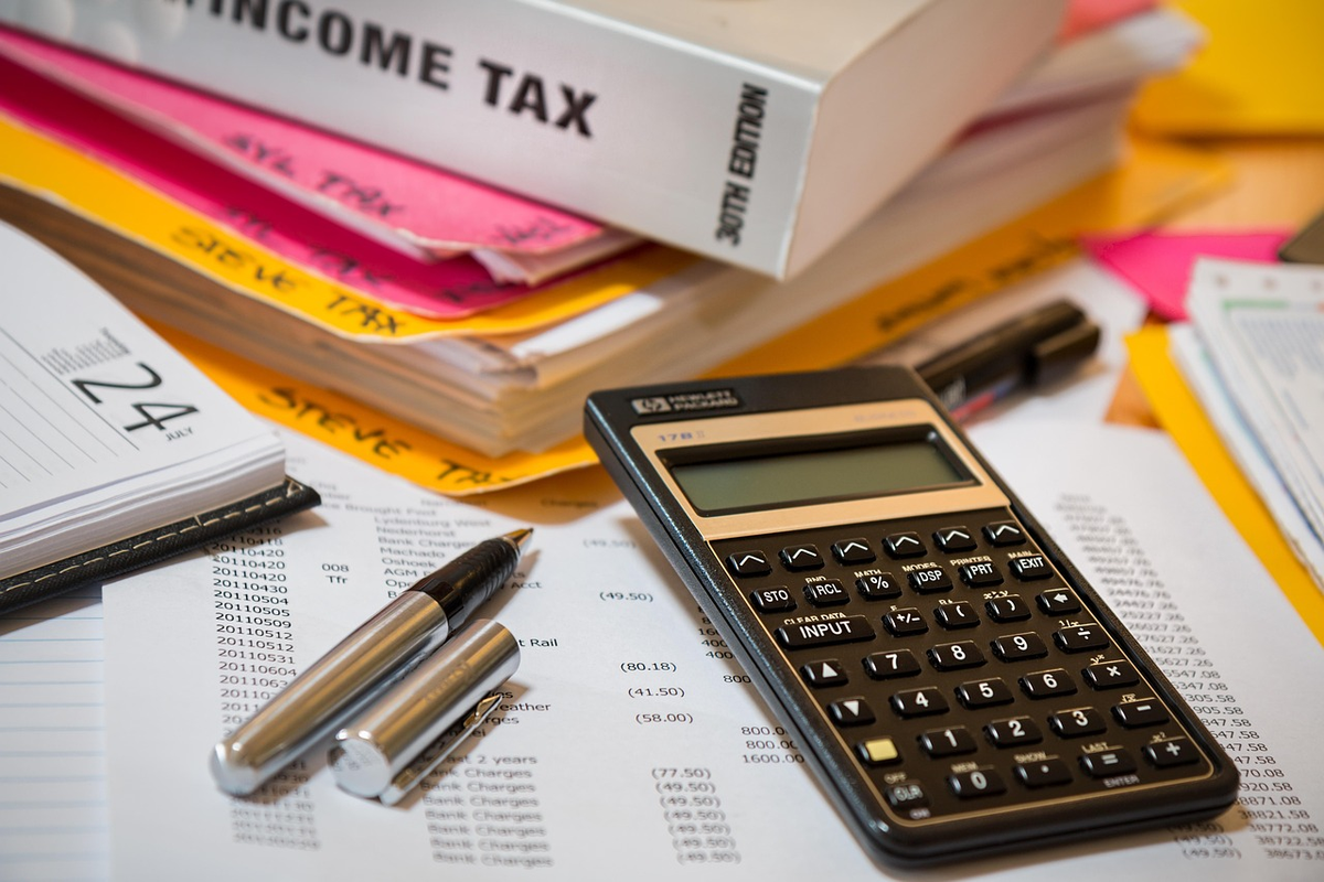A diverse set of investment symbols, such as a stock graph, a house silhouette, and a gold coin, each connected to a distinct, varying tax percentage symbol, visually representing the different tax implications for various investment types.
