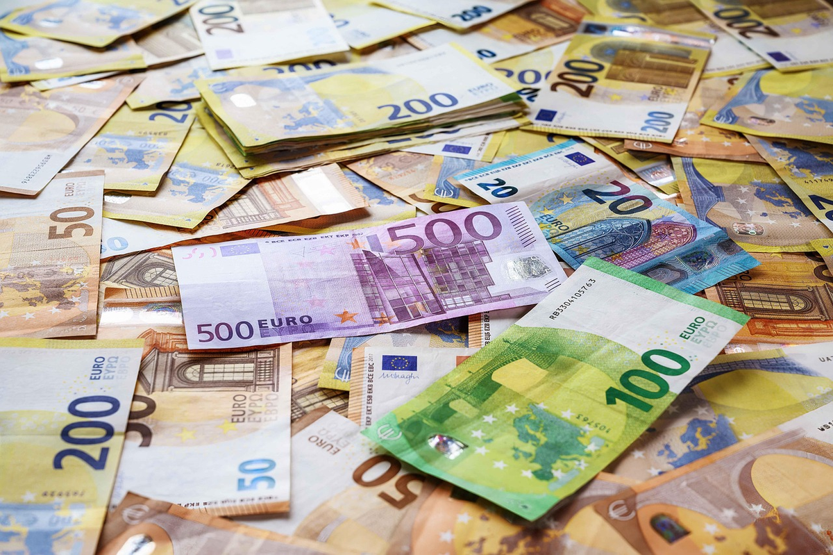 A transparent, stylized financial filter visibly siphoning off a significant portion from a stream of incoming currency (banknotes and coins), with the diverted amount labeled 'Taxes and Social Contributions' and the remaining, smaller flow continuing as 'Net Income'.