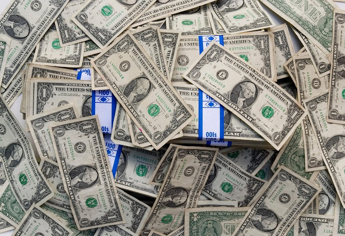 A hand thoughtfully adjusting clear, categorized digital sliders representing income and various expense categories on a clean financial dashboard, symbolizing active budget management and debt control.