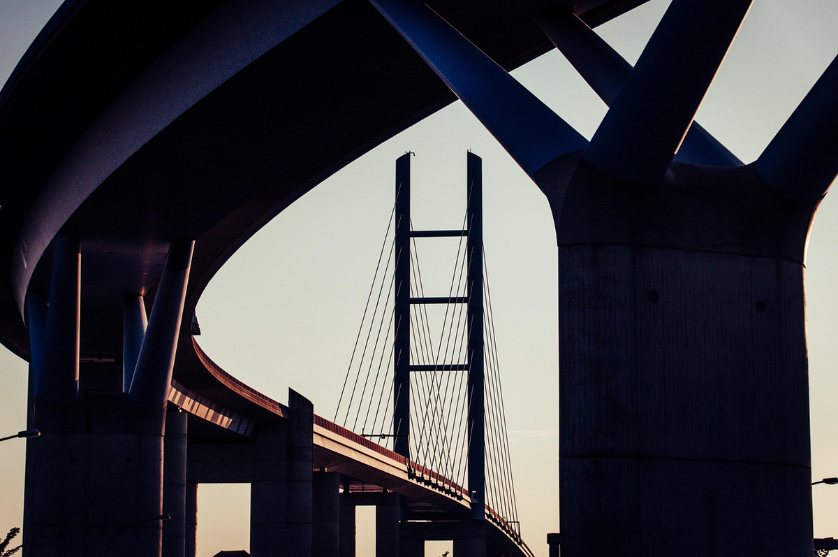 A side-profile view of a person standing firmly on a three-tiered, ascending structure, where each distinct layer represents a different pillar of the pension system, symbolizing a progressive and secure path towards long-term financial well-being.