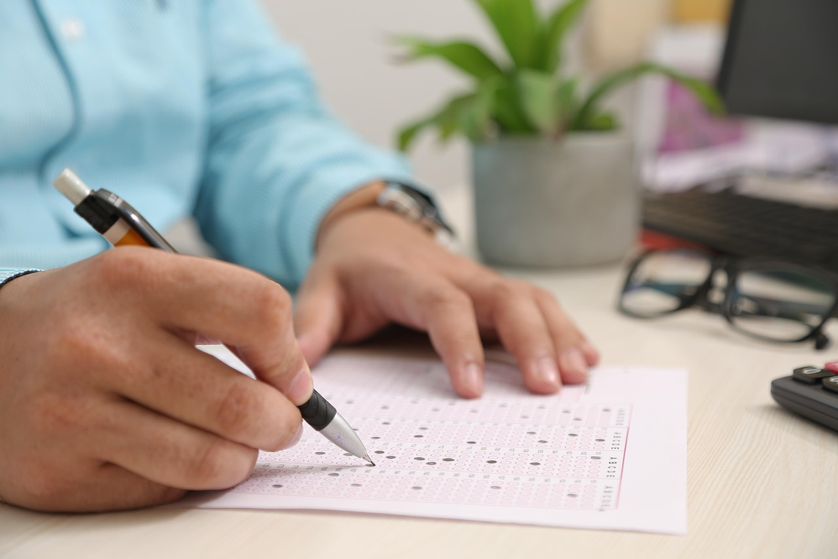 A close-up of a hand completing a digital financial application, with a prominent 'verified' icon and a progress bar, symbolizing the stringent conditions and detailed process required for investment access.