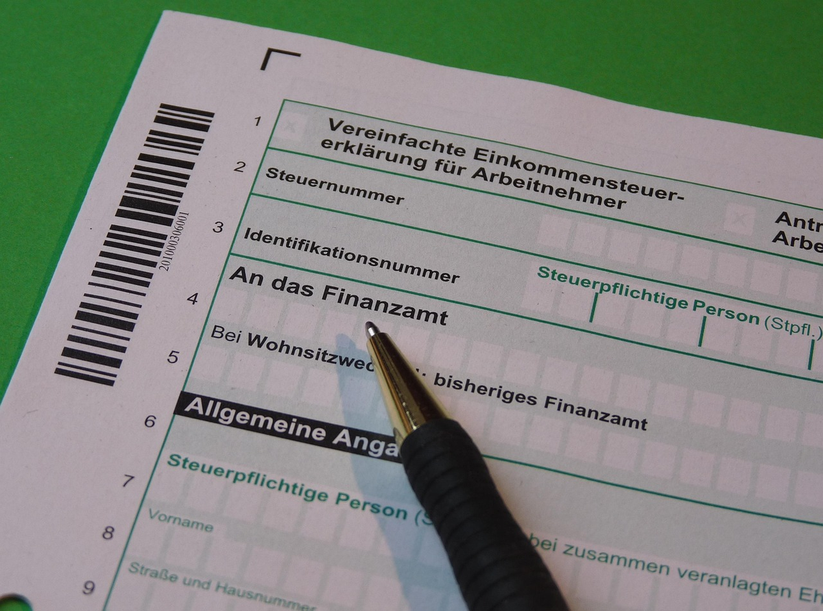 A person's hands meticulously analyzing a detailed financial ledger overlaid with a translucent globe, featuring international currency symbols, tax stamps, and investment charts, symbolizing precise cross-border accounting and tax optimization.