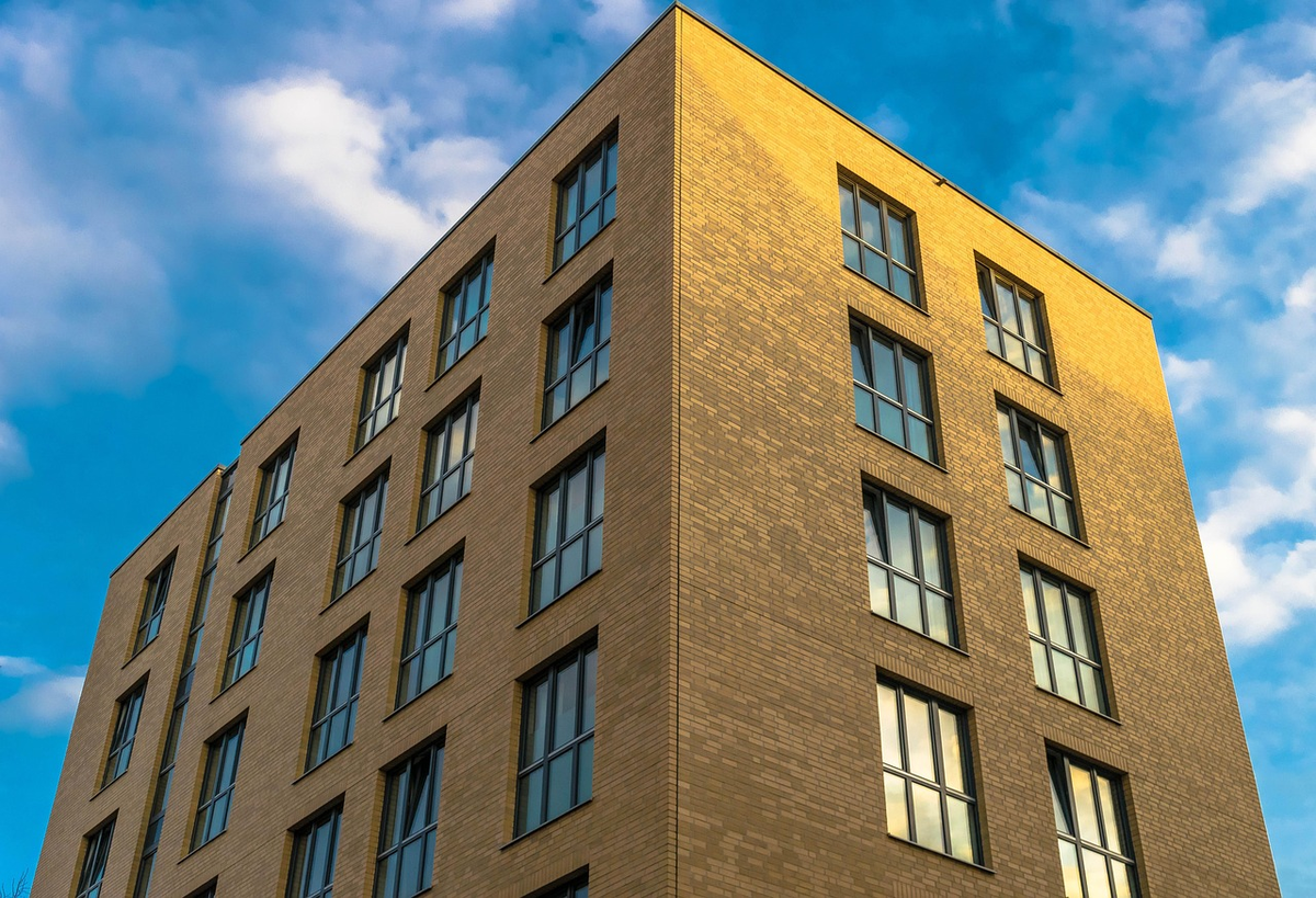 A sophisticated architectural illustration seamlessly integrating distinct, clean elements of a modern office building, a sleek retail storefront, and a large industrial warehouse, arranged to form a cohesive structure that subtly suggests upward growth, symbolizing the diverse yet strategic nature of commercial real estate investment.