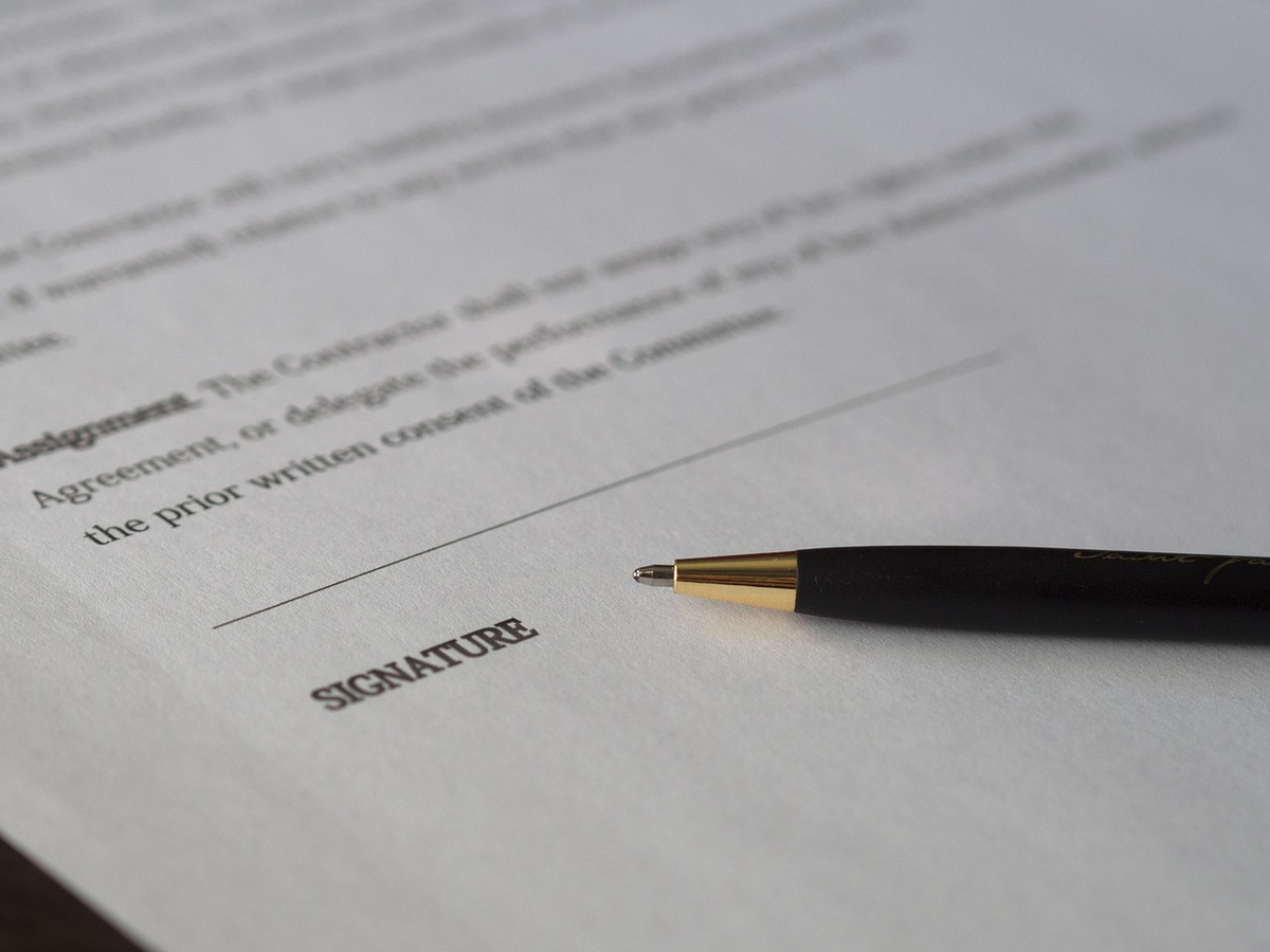 A person carefully reading a glowing, transparent financial document, such as a loan agreement or a Standard European Consumer Credit Information Form (SEF), with key terms visibly highlighted, symbolizing clarity, understanding, and informed decision-making regarding rights and obligations before committing to a loan.